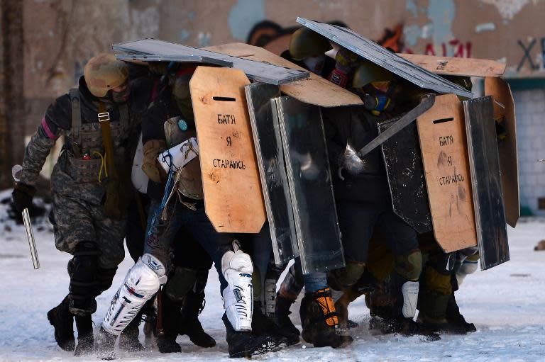 Ukrainian opposition protesters train with riot shields in the center of Kiev, on January 30, 2014