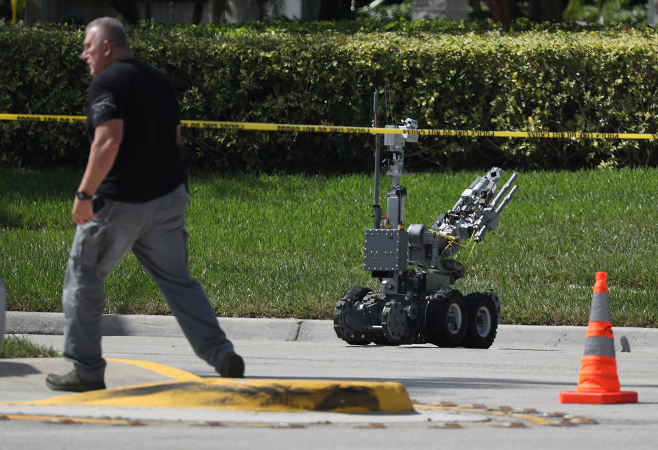 The Broward Sheriff’s Office bomb squad deploys a robotic vehicle to investigate a suspicious package in the building where Debbie Wasserman Schultz’s office is located. Source: Getty Images