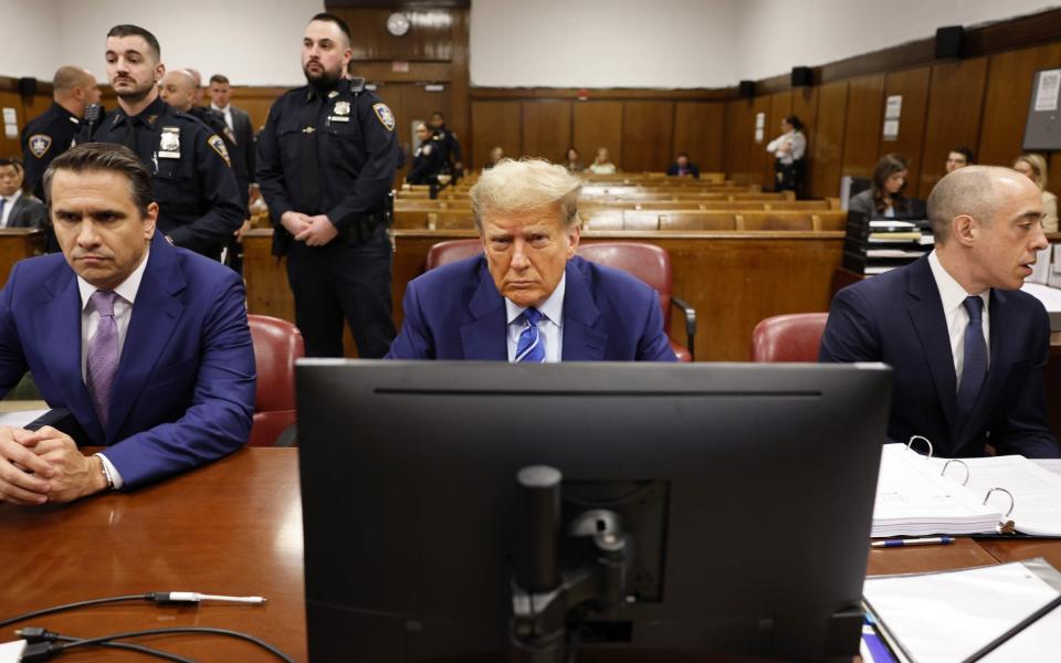 Donald Trump alongside attorneys Todd Blanche (left) and Emil Bove (right) during the second day of his criminal trial at Manhattan Criminal Court