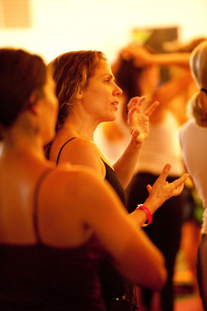 Yoga teacher Seane Corn speaking during her yoga class.