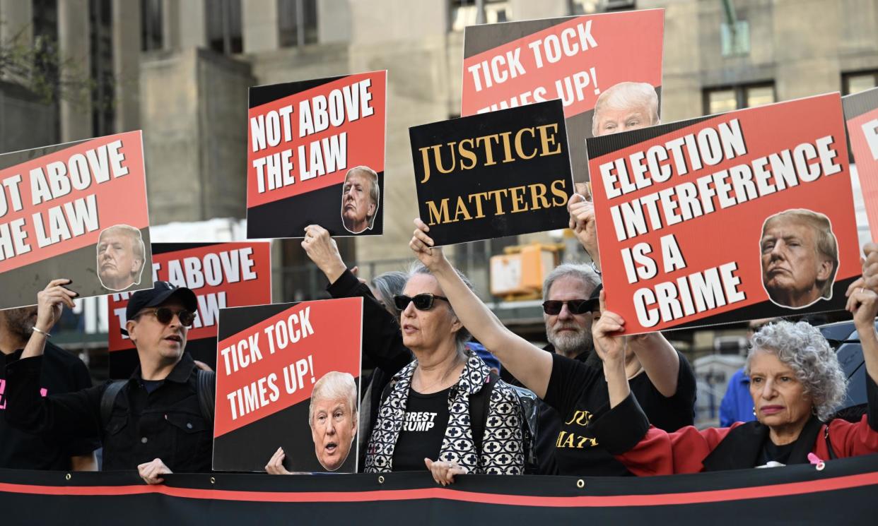 <span>People protest outside court in New York on 15 April. </span><span>Photograph: Anadolu/Getty Images</span>