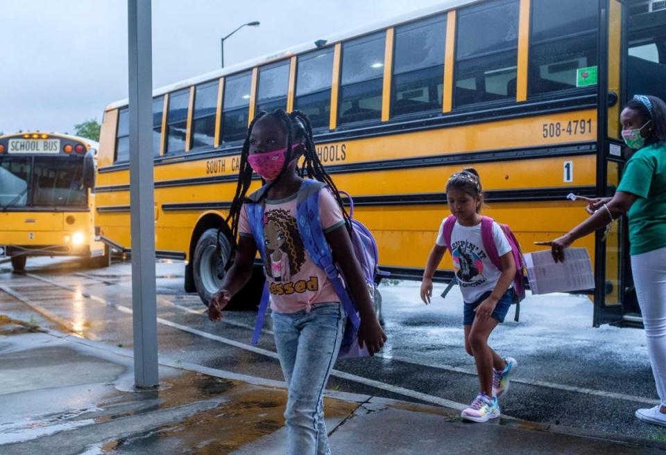 Students arrive at Homewood Elementary via bus on Tuesday. In-person classes resumed today in Horry County Schools. While many teachers, parents and students expressed excitement at being back, some are concerned the the latest spike of COVID-19 cases in South Carolina and what that might mean for the 2021-2022 school year. Aug. 11, 2021.