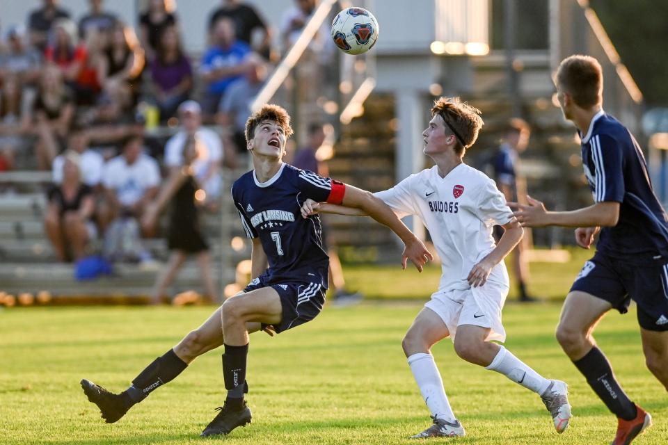 East Lansing's Holden Knapp, left, and Mason's Blendi Jahiri go after the ball during the first half on Thursday, Aug. 19, 2021, at the East Lansing Soccer Complex in East Lansing.