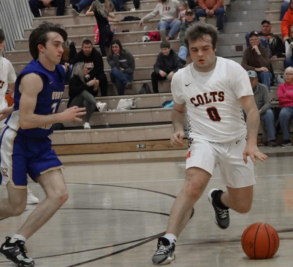 Meadowbrook senior Kordell West (0) attempts to keep sophomore Conner Hill (3) of West Muskingum away from the basketball during Tuesday's MVL matchup in Byesville.