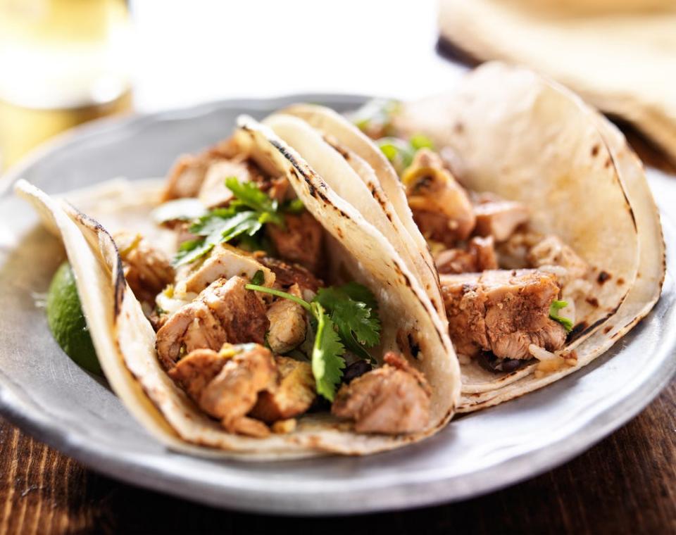 chicken tacos with cilantro on a plate