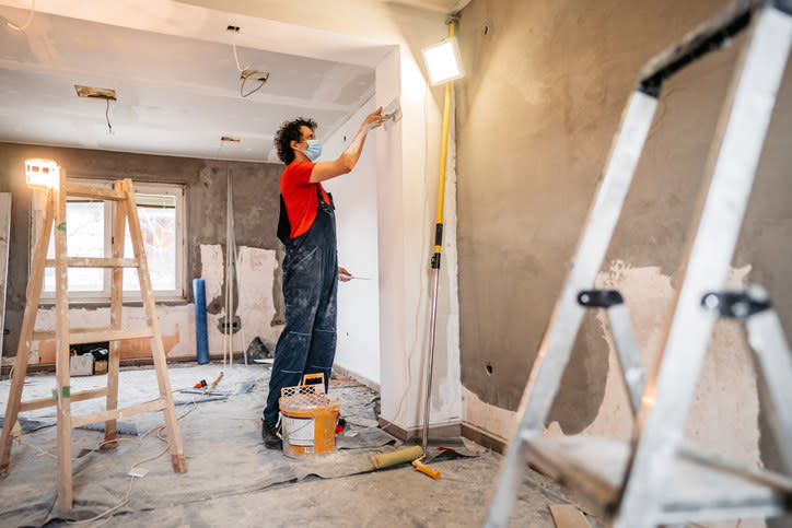 A man painting a wall.