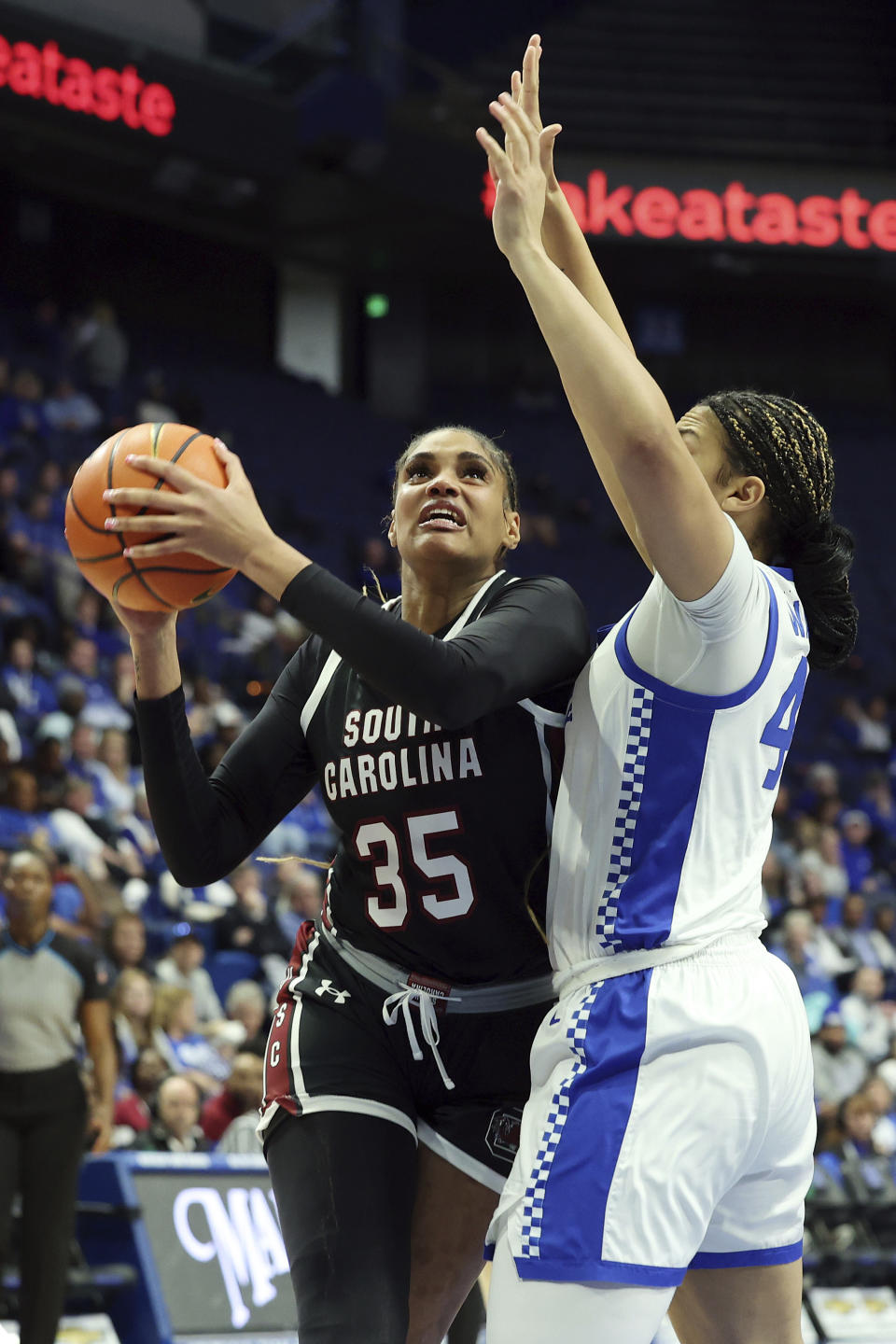 South Carolina's Sakima Walker (35) is pressured by Kentucky's Janae Walker, right, during the second half of an NCAA college basketball game Sunday, Feb. 25, 2024, in Lexington, Ky. (AP Photo/James Crisp)