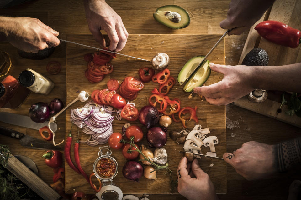 Hands chopping vegetables.