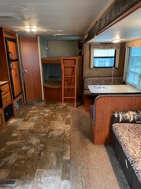 BEFORE: The bunks were painted white, a feature wall was painted in Behr's Smoke Bush Rose, and new curtains make the sleeping areas more inviting in this camper.