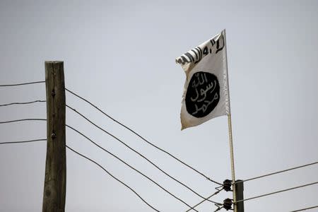 FILE PHOTO - A Boko Haram flag flies in Damasak, Nigeria March 24, 2015. REUTERS/Joe Penney/File Photo