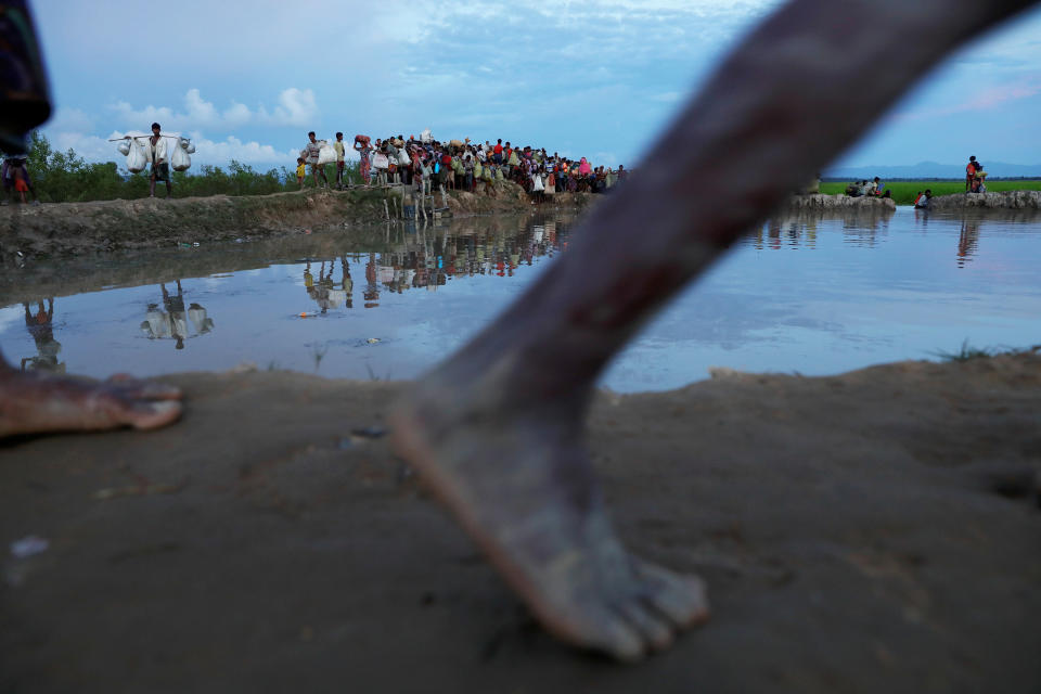 Rohingya refugees who fled from Myanmar make their way through the rice field after crossing the border in Palang Khali, Bangladesh, on Oct. 9. Reuters photographer Damir Sagolj: "We were covering a tragic accident in which a boat carrying Rohingya refugees capsized and many, mostly children, died when we got a tip from colleagues that two hours drive to the north, thousands of refugees stranded on the border were finally crossing into Bangladesh. I rushed in that direction and made it just before the darkness to witness unreal scenes. Many thousands of people, carrying the sick and injured, the elderly and children, and their few possessions were slowly making their way through the mud and rice fields to the relative safety of Bangladesh. I thought I had witnessed enough tragedy that day for a lifetime, and yet it was just another day in a never-ending story for the Rohingya people fleeing Myanmar."