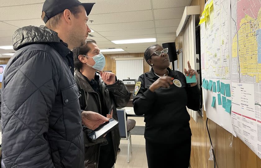Homeless count volunteers JC Cangilla and David Gaxiola listen to Inglewood deployment site coordinator Cinder Eller-Kimbell describe the area they will be counting. On Jan, 25, 2023.