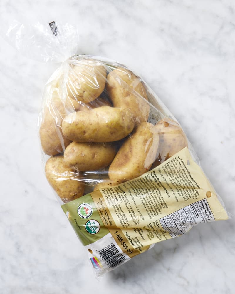 Overhead view of potatoes in a plastic bag.