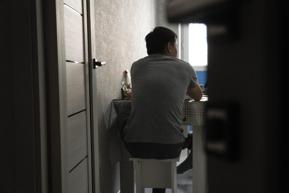 A Russian soldier who goes by the nickname Sparrow sits at his kitchen table in his apartment in Astana, Kazakhstan, in late 2023. After being forcibly conscripted, he ran away from his barracks because he didn't want to kill anyone. "I don't want anything in life. I have no interest in my own affairs," he said. "I just sit all day on the Internet, on YouTube, and read news, news, news of what's going on in Ukraine, and that's it." (AP Photo)