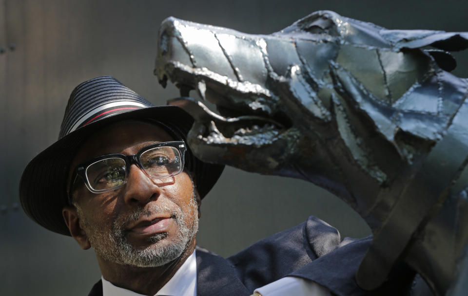 Rev. Isreal Grant looks at a statue of attacking dogs at Kelly Ingram Park in Birmingham, Ala., Friday, Sept. 6, 2013. When he was 15, Grant boarded an overcrowded bus and, finding no place at the back, sat down beside an elderly white woman. He was arrested and jailed overnight, without even being given a chance to call his parents. "My father found me the next morning," Grant recalls. "They had been checking all the funeral homes and all the police stations. My father cried like a baby." Because of his good grades and lack of a record, the judge agreed to dismiss the charges. (AP Photo/Dave Martin)