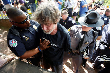 A counter-protester is detained as members of the Ku Klux Klan rally in opposition to city proposals to remove or make changes to Confederate monuments in Charlottesville, Virginia, U.S. July 8, 2017. REUTERS/Jonathan Ernst