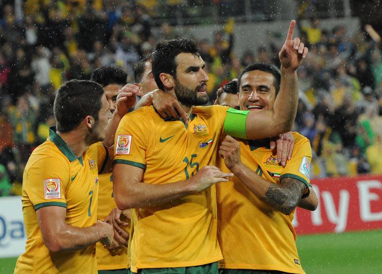 Australia's Mathew Leckie (L) congratulates Mile Jedinak (C) and Tim Cahill (R) after a goal during the first round Asian Cup football match between Australia and Kuwait in Melbourne on January 9, 2015