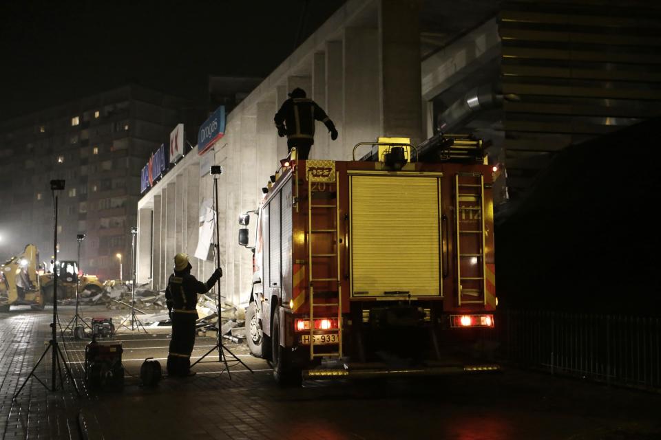 Firefighters work at the site of the collapsed Maxima supermarket in Riga