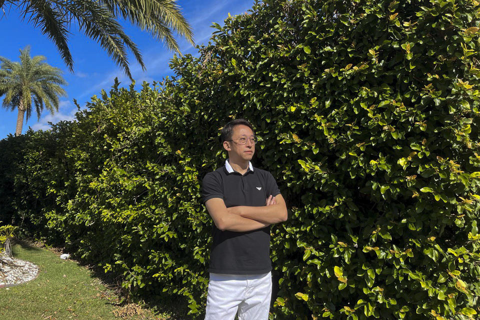 In this photo released by Miao Yu, Miao Yu poses for a photo in Orlando, Florida on Sunday, Jan. 29, 2023. Yu, a former bookseller, left China after his store was shut down for political reasons. (Miao Yu via AP)