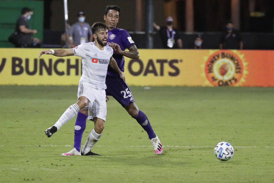 Los Angeles FC forward Diego Rossi (9) battles for the ball with Orlando City defender Antonio Carlos (25) during the second half of an MLS soccer match, Friday, July 31, 2020, in Orlando, Fla. (AP Photo/John Raoux)