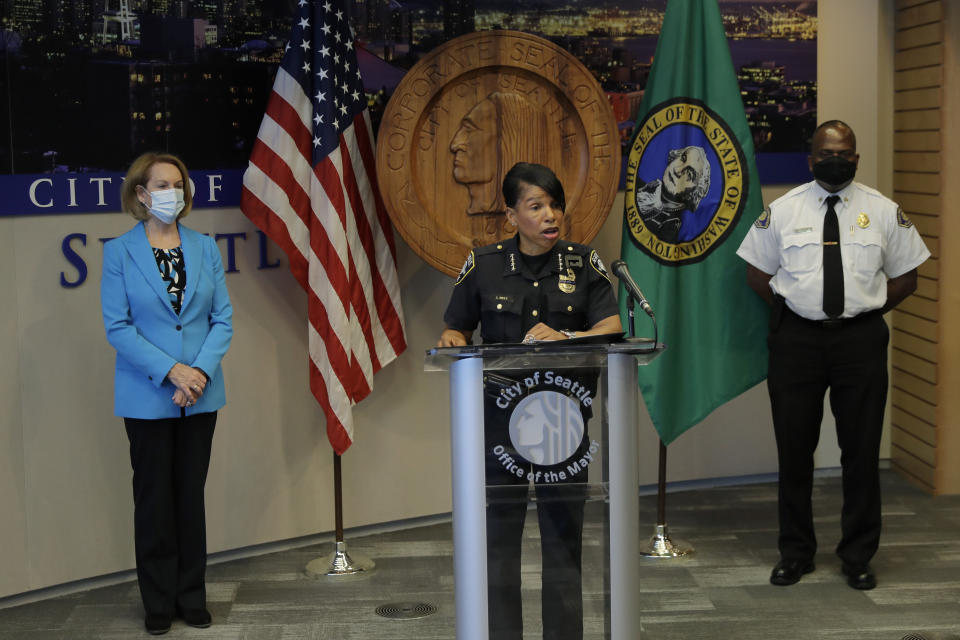 Police Chief Carmen Best, center, speaks at at a news conference, Monday, July 13, 2020, at City Hall in Seattle as Mayor Jenny Durkan, left, and Fire Chief Harold Scoggins , right, look on. Durkan and Best were critical of a plan backed by several city council members that seeks to cut the police department's budget by 50 percent. (AP Photo/Ted S. Warren)