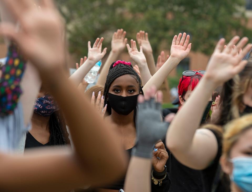 Black Lives Matter protest and march at Kent State University. A protester looks ahead during a â€œhands upâ€ call and response. 