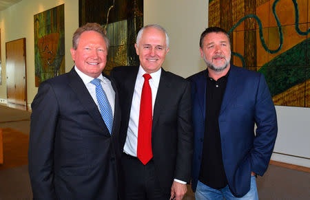 Australian mining magnate Andrew Forrest stands with Australian Prime Minister Malcolm Turnbull and actor Russell Crowe as they attend a ceremony announcing his pledge of A$400 million, the country's biggest philanthropic donation by a living person, to a host of causes covering health, education and fighting modern slavery, at Parliament House in Canberra, Australia, May 22, 2017. AAP/Mick Tsikas via REUTERS