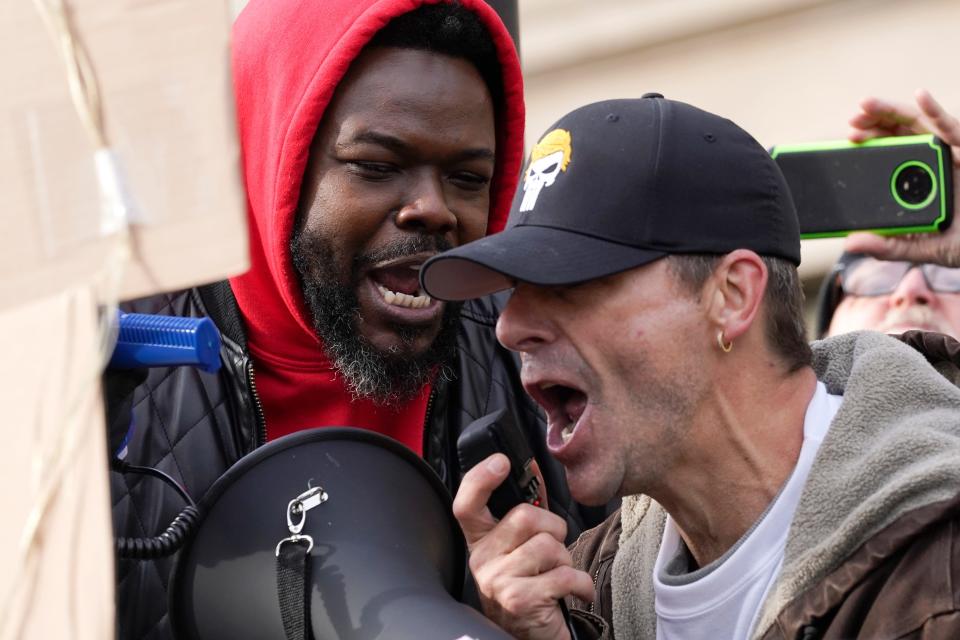 Protesters confront each other outside the Kenosha County Courthouse, Tuesday, Nov. 16, 2021, in Kenosha, Wis., during the Kyle Rittenhouse murder trial.