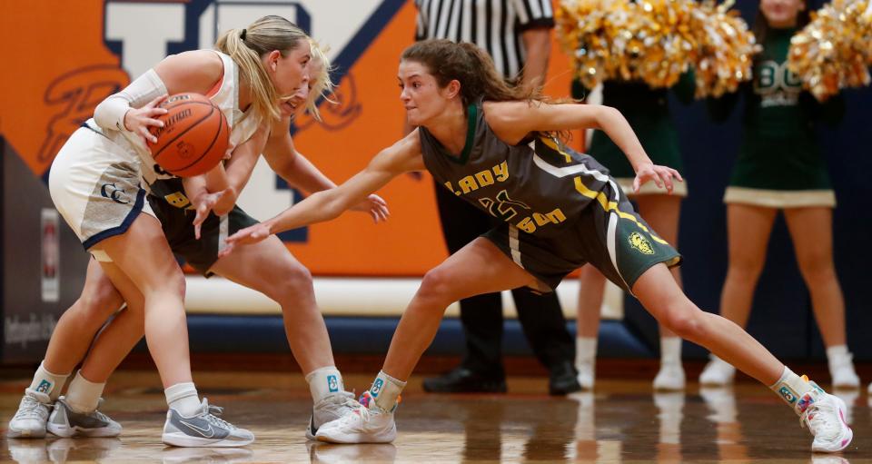 Central Catholic Knights Grace Bordenet (3) is guarded by Benton Central Bison Rachel Tolen (21) during the IU Health Hoops Classic girl’s basketball third place game, Saturday, Nov. 18, 2023, at Harrison High School in West Lafayette, Ind. Benton Central won 63-42.