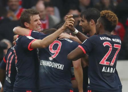 Football Soccer - VfB Stuttgart v Bayern Munich - German Bundesliga - Mercedes-Benz Arena, Stuttgart, Germany 09/04/16 Bayern Munich's Douglas Costa celebrates with his team mates after scoring a goal REUTERS/Kai Pfaffenbach