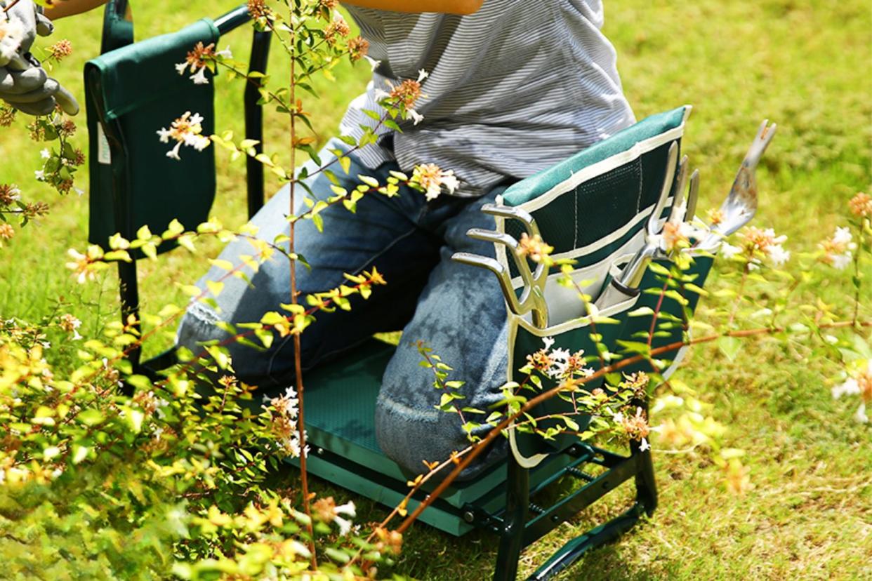 someone using the gardening bench as a kneeler