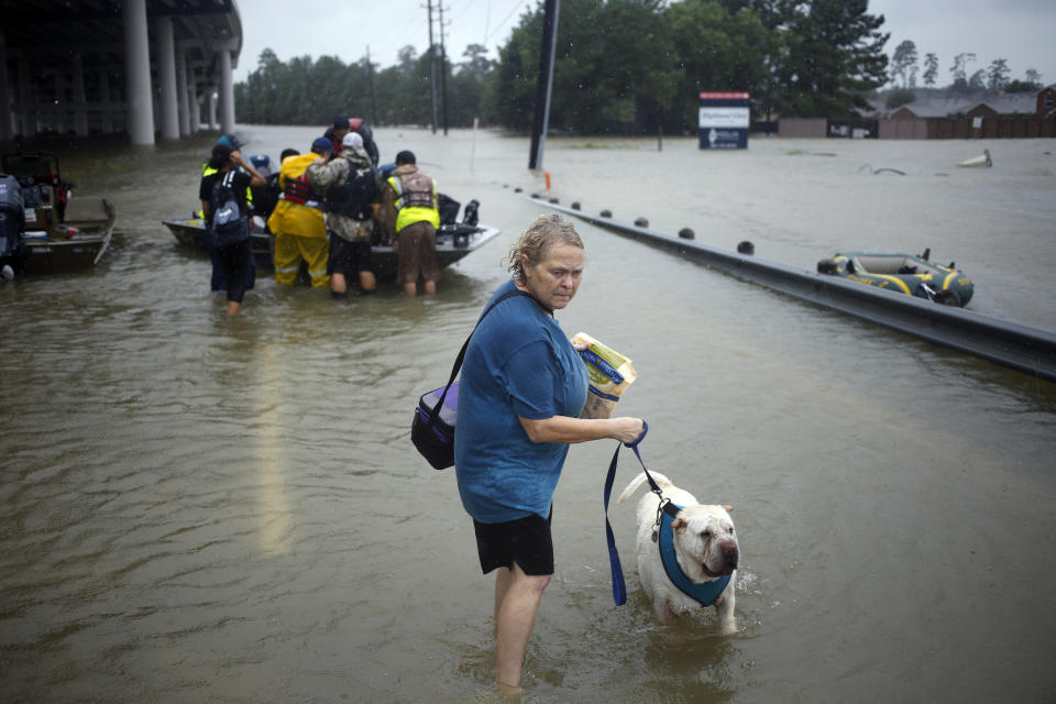 A woman holds her dog after being rescued from rising floodwaters due to Hurricane Harvey in Spring, Texas, U.S., on Monday, Aug. 28, 2017. A deluge of rain and rising floodwaters leftï¿½Houstonï¿½immersed and helpless,ï¿½crippling a global center of the oil industry and testing the economic resiliency of a state thats home to almost 1 in 12 U.S. workers. Photographer: Luke Sharrett/Bloomberg via Getty Images