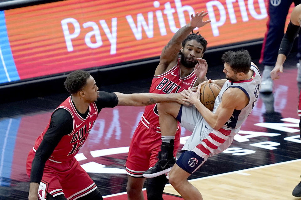 Chicago Bulls' Daniel Gafford, left, and Coby White stop Washington Wizards' Raul Neto from driving to the basket during the first half of an NBA basketball game Monday, Feb. 8, 2021, in Chicago. (AP Photo/Charles Rex Arbogast)