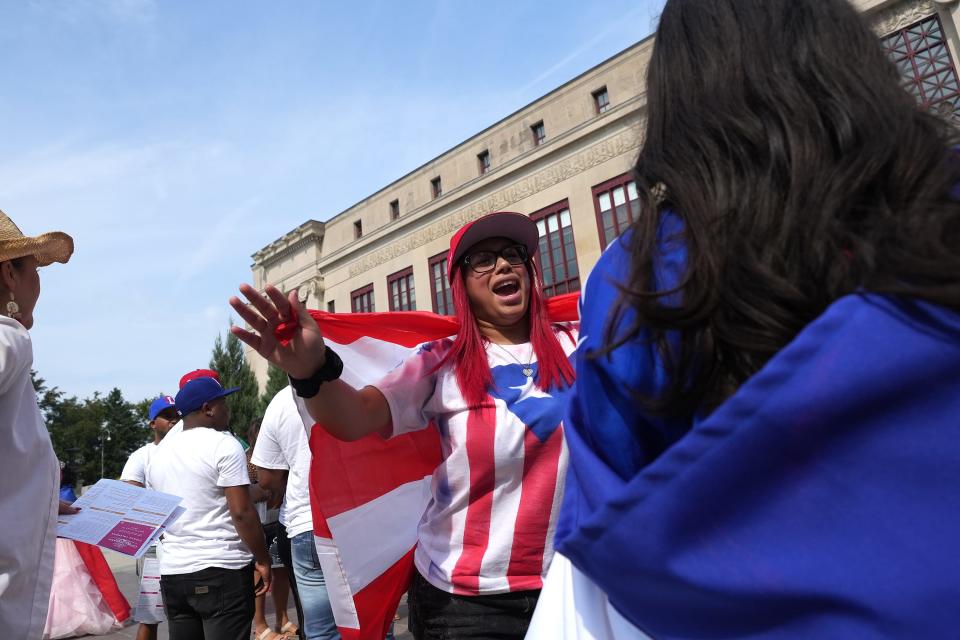 Yarianis Garcia dances with friend Lani Lino during a gathering on Sept. 17, at City Hall at the end of the first Columbus Latine/Hispanic Heritage Month parade.