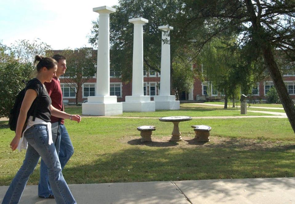 Students walk to class in front of the columns, a landmark on the campus of Northwestern State University.