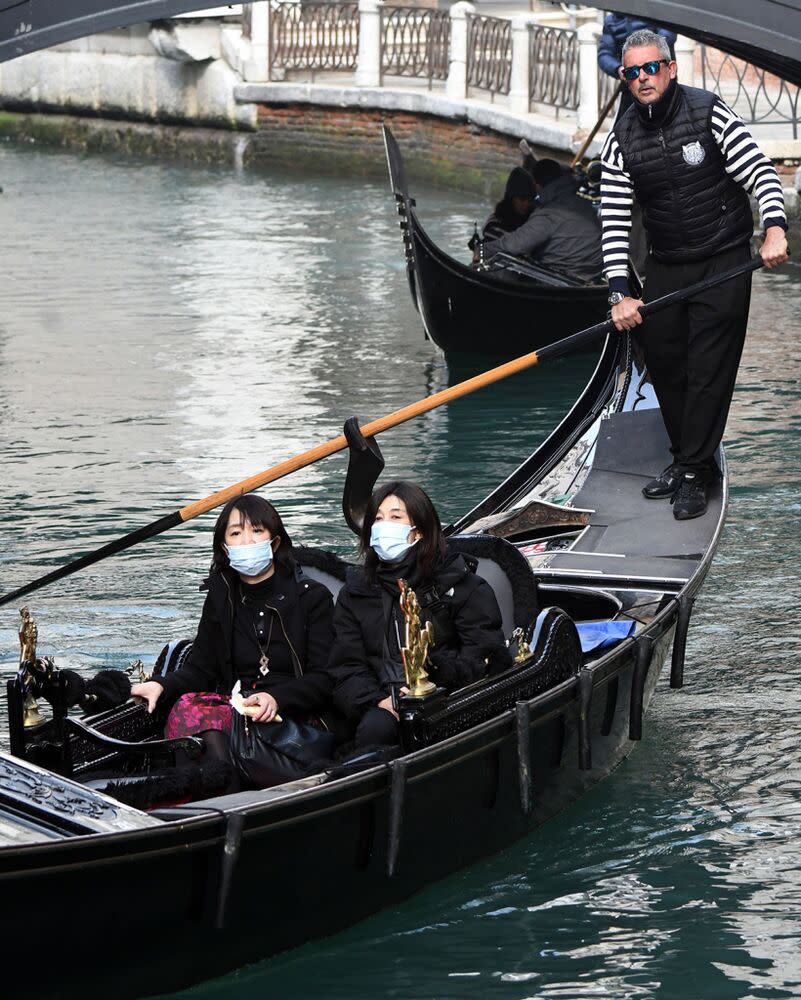 Tourists in Venice wear face masks | ANDREA PATTARO/AFP via Getty