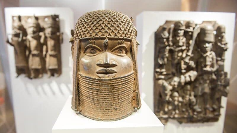 Three pieces of Benin Bronzes are displayed at Museum for Art and Crafts in Hamburg, Germany, Wednesday, Feb. 14, 2018. (Daniel Bockwoldt/dpa via AP)