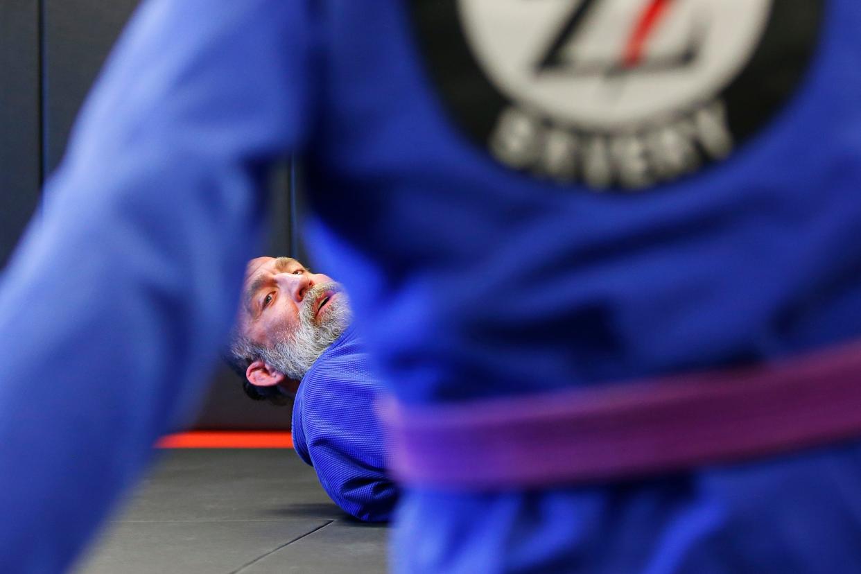 Students look on as Danny Savery demonstrates a hold at the new Danny Savery Brazilian Jiu-Jitsu on Sarah's Way in Fairhaven.