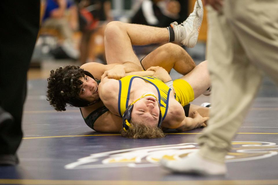 Naples’ Declan Finucan and Palmetto Ridge’s Jean Valoria wrestle in the 126-pound championship during the 2022 CCAC Wrestling Tournament, Wednesday, Jan. 26, 2022, at Naples High School in Naples, Fla.Palmetto Ridge won the 2022 CCAC title.