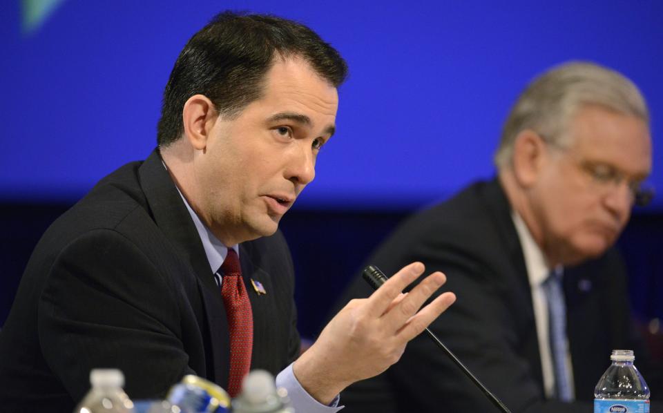 Republican Governor Scott Walker of Wisconsin makes remarks during a "Growth and Jobs in America" discussion at the National Governors Association Winter Meeting in Washington February 23, 2014. The governors will be meeting with administration officials, members of Congress and business leaders as they discuss the nation's economy, education issues, environmental concerns and health and human services. REUTERS/Mike Theiler (UNITED STATES - Tags: POLITICS)