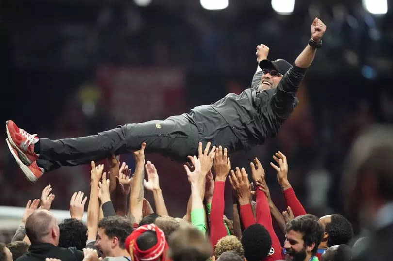 The Liverpool team celebrate by raising Jurgen Klopp after winning the Champions League