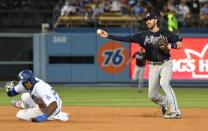 Jun 9, 2018; Los Angeles, CA, USA; Atlanta Braves shortstop Dansby Swanson (right) turns a double play over Los Angeles Dodgers right fielder Yasiel Puig (66) in the 9th inning at Dodger Stadium. Mandatory Credit: Richard Mackson-USA TODAY Sports