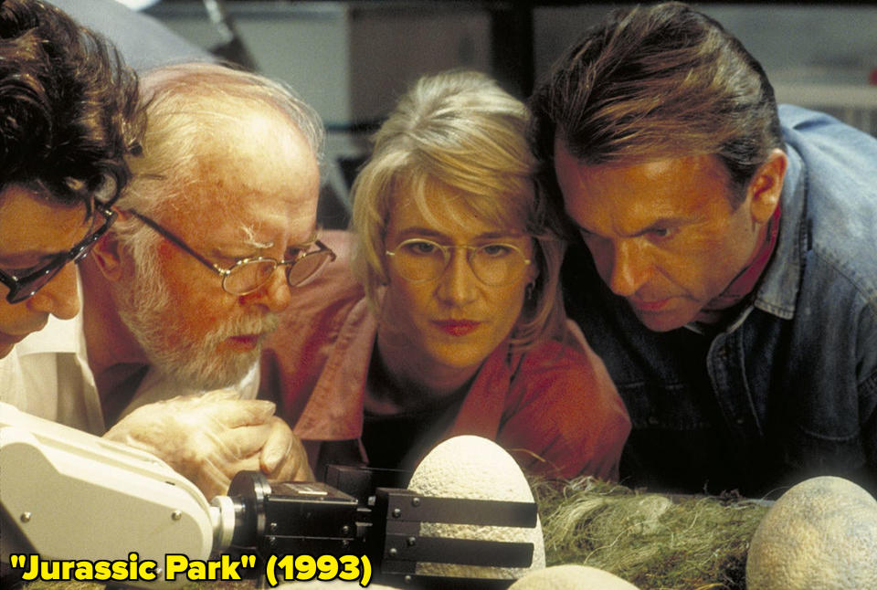 Laura Dern among other castmates looking at a dinosaur egg in "Jurassic Park"