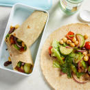 <p>Zesty Greek salad packed with tomatoes, cucumber and olives--plus chickpeas for a protein punch--gets tucked into a whole-wheat wrap for a healthy vegan lunch that's easy to pack for work. It's so flavorful and satisfying, you won't miss the feta!</p> <p> <a href="https://www.eatingwell.com/recipe/264062/greek-salad-wraps/" rel="nofollow noopener" target="_blank" data-ylk="slk:View Recipe;elm:context_link;itc:0;sec:content-canvas" class="link ">View Recipe</a></p>