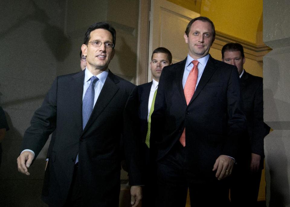 FILE - In this Oct. 16, 2013 file photo House Majority Leader Eric Cantor of Va., left, arrives for a meeting with House Republicans on Capitol Hill in Washington. Congress returns to work on Jan. 6, 2014, with election-year politics certain to shape an already limited agenda. (AP Photo/Carolyn Kaster, File)