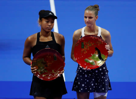 Tennis - Pan Pacific Open Women's Singles Final match - Arena Tachikawa Tachihi, Tokyo, Japan - September 23, 2018. Karolina Pliskova (R) of Czech Republic, flanked by second-placed Naomi Osaka of Japan, poses with her victory trophy. REUTERS/Toru Hanai