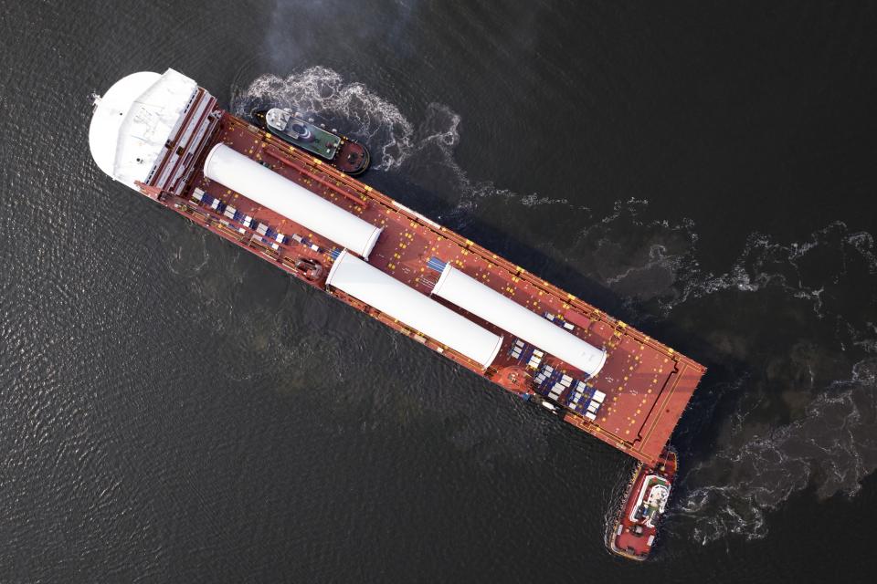 File - The ship UHL Felicity, carrying massive parts for offshore wind turbines, arrives to dock on May 24, 2023, in New Bedford, Mass. A transition from fossil fuels to renewable energy is one of the trends which could intensify global inflation pressures in the coming years. (AP Photo/Rodrique Ngowi, File)