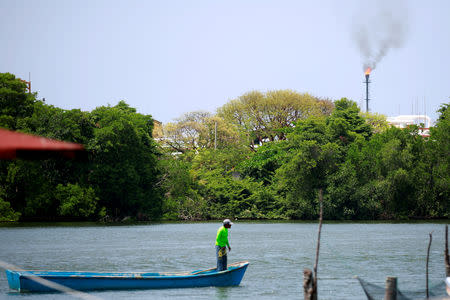 FILE PHOTO: A fisherman navigates in front of the Pemex oil port know as Dos Bocas in Paraiso, Tabasco, Mexico April 24, 2018. REUTERS/Carlos Jasso/File Photo