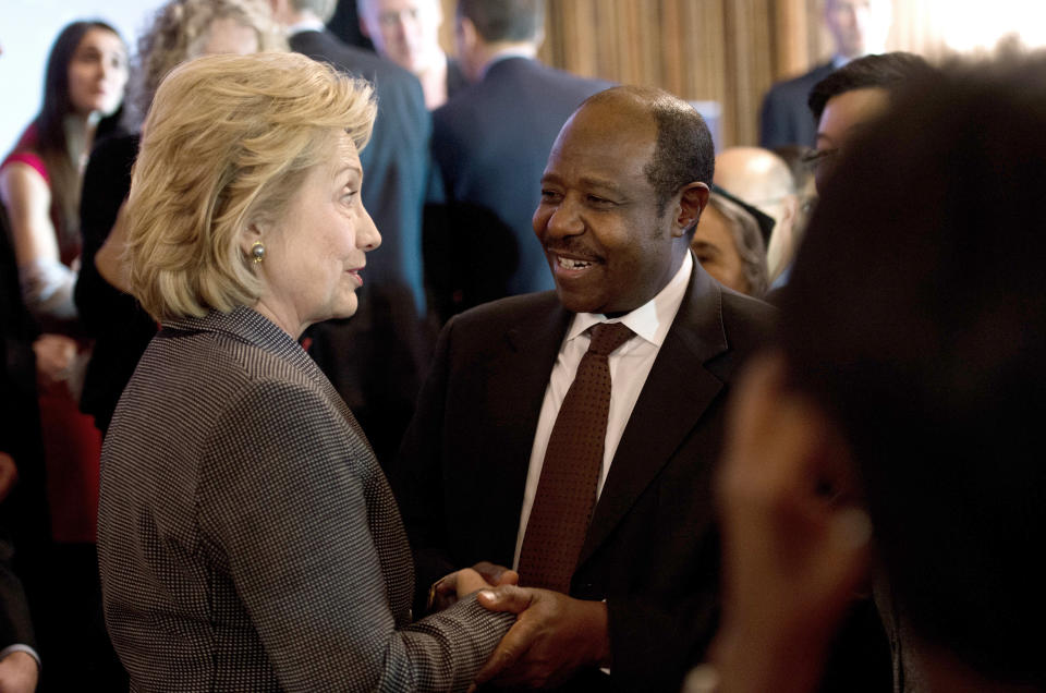 Former U.S. Secretary of State Hillary Clinton speaks with Rwandan 2011 Lantos Human Rights Prize laureate Paul Rusesabagina after receiving the 2013 Lantos Human Rights Prize during a ceremony on Capitol Hill in Washington on December 6, 2013. (Photo credit should read NICHOLAS KAMM/AFP/Getty Images)