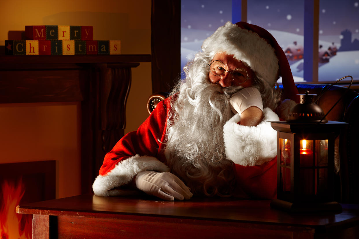 Close up of bored Santa sitting in his animated grotto